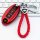 Red infiniti q50l/qx50 key cover with braided leather strap and branded logo, displayed on a keyboard background.