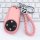 Elegant pink nio es8 key cover with braided leather strap and sleek design, offering premium protection for your car key.