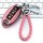 Pink nissan key cover with braided leather loop, designed for altima, sentra, x-trail, and more, displayed on a keyboard back...