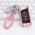 Elegant pink leather key cover for gac trumpchi gs4, featuring a braided strap and sleek design, displayed on a keyboard back...