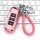 Elegant pink baojun 730 key cover with braided leather keychain, designed for models 510/560/530/e200/360/310w/630, displayed...