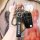 Hand holding a roewe 350 key cover with 360° protection, featuring a sleek black design, carabiner, and branded roewe strap.