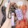 A hand holds a roewe 350 key cover in lavender, featuring a sleek design with a car emblem and roewe text, offering 360° prot...