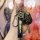 A hand holds a nissan key fob with a sleek black leather key cover, featuring the nissan logo and a carabiner attachment, des...