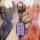 A hand holds a sleek, purple nissan qashqai key cover with a premium leather shell, featuring a carabiner and the nissan logo...
