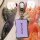 A hand holds a sleek xiaomi-powered xiao peng p7 key cover, featuring a purple leather design with the xpeng logo. the keycha...