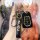 A hand holds a sleek black isuzu d-max key cover, featuring a smart key protector with a metallic finish and isuzu branding, ...