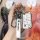 A hand holds a skoda key fob with a premium leather cover, featuring a sleek design and a carabiner for easy attachment. perf...