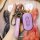 A hand holds a purple wuling kaijie key cover, featuring a sleek design with a carabiner and leather strap, showcasing the 20...