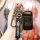 A hand holds a chery tiggo 8 key cover, featuring a sleek black leather design with the chery logo and a matching keychain, o...