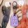 A hand holds a purple cadillac key cover with a sleek design, featuring buttons for lock, unlock, and alarm, set against a vi...