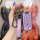 A hand holds a purple jeep renegade key cover, featuring a foldable leather design with a jeep logo and functional buttons, s...