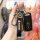 A hand holds a sleek black key cover for the changan suzuki sx4, featuring a leather strap with suzuki branding and a matchin...