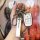 A hand holds a renault key fob with a sleek white and silver cover, featuring the renault logo on a leather tag, set against ...