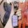 A hand holds a sleek, lavender bideven m8/m7/m6/m5/v7 ev key cover with a metallic clasp, set against a vibrant backdrop feat...