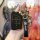 A hand holds a sleek black jac key cover for sehol e50a, jiayue a5 & ruifeng s4, featuring gold accents and a matching leathe...