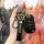 A hand holds a sleek black peugeot key cover, featuring the brands logo and a matching lanyard, designed for models like 308,...