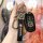 A hand holds a sleek black buick key cover for regal, lacrosse & encore, featuring a leather strap with the buick logo and a ...