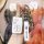 A hand holds a sleek toyota key cover with a matching fob, featuring the toyota logo and a white strap, designed for models l...