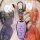 A hand holds a sleek, lavender volkswagen jetta x8 plus key cover with a metallic vw logo, set against a vibrant, artistic ba...