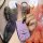 A hand holds a sleek, lavender buick envision s gs key cover with a metallic clip and button design, set against a vibrant, a...