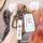 A hand holds a sleek white toyota key cover with a branded strap, designed for women and compatible with models like corolla,...