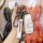 A hand holds a white key cover for beijing auto models bj40, bj60, eu5, and eu7, featuring a senova logo strap and a sleek de...