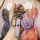 A hand holds a stylish purple mini cooper key cover for f54/f55/f56/f60, featuring a leather strap with the mini logo and a s...